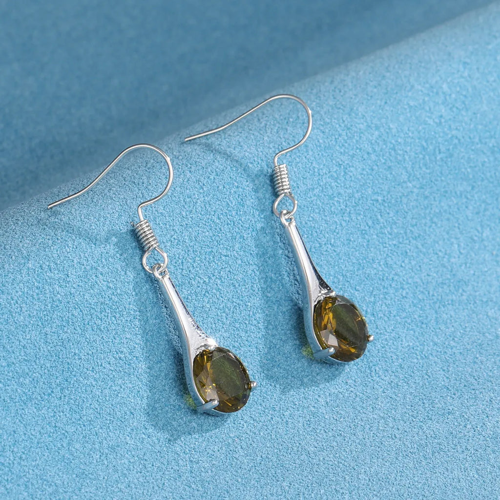 Olive green topaz coloured water drop shape earrings with minimalist retro styling on white background