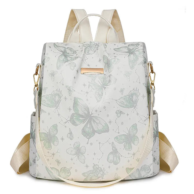 Butterfly print PU leather backpack in purple shown from the side, featuring sewing line details and shoulder straps.