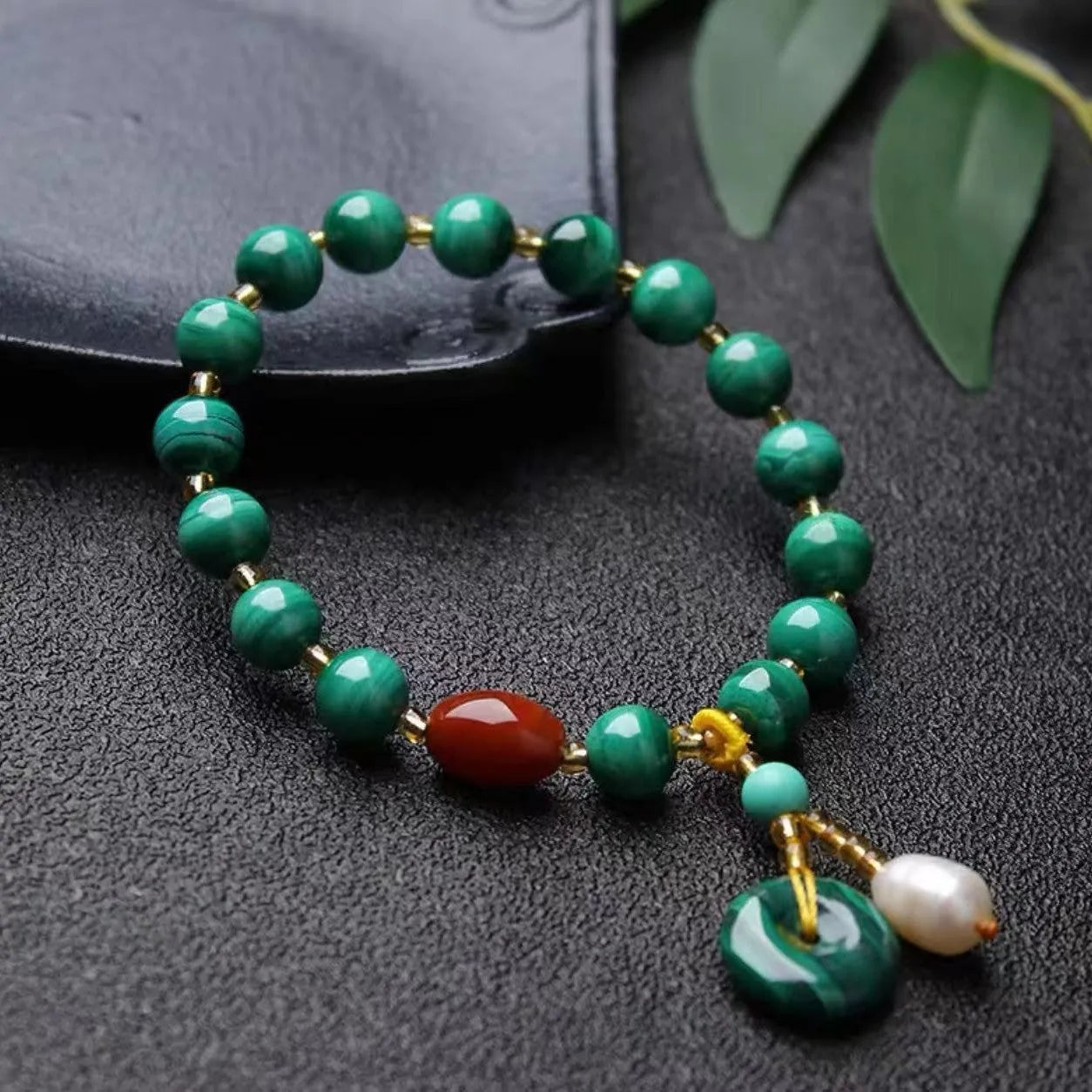 Natural green malachite and red agate barrel bead bracelet on wrist, bead size 7-8mm.
