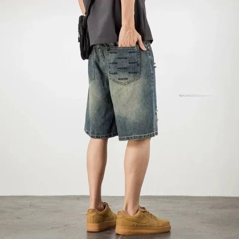 Blue distressed denim men's shorts with a loose retro fit and hole detailing