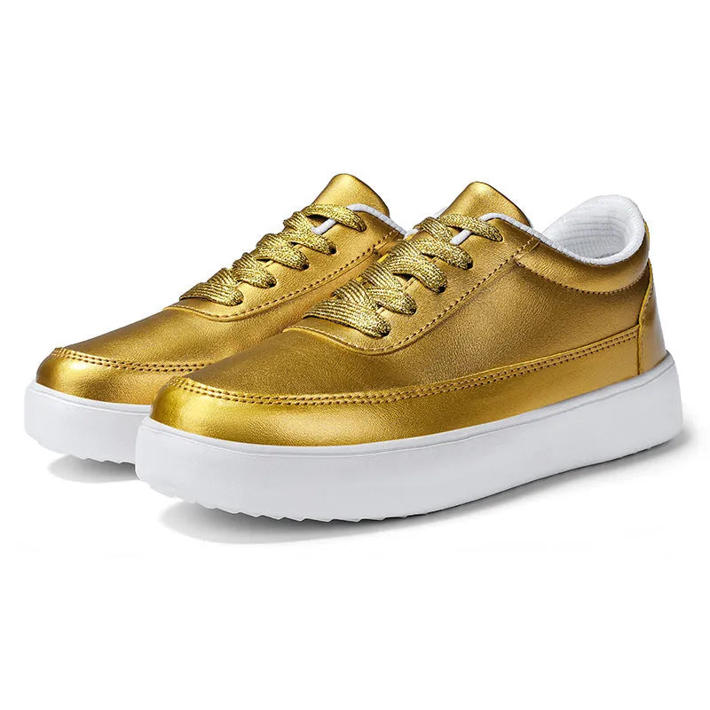 Women's gold leather flat casual lace-up shoes on a white background.