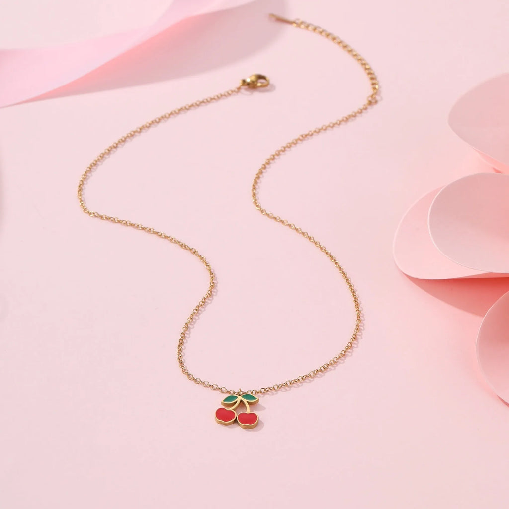 Four-piece cherry jewellery set showing necklace, bracelet, earrings, and ring with 18K electroplated finish