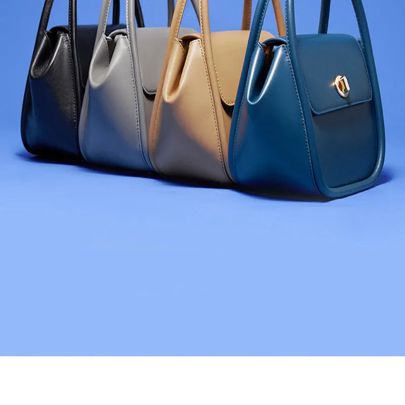A women's cow leather wing-shaped handbag with a latch closure and a single shoulder strap.