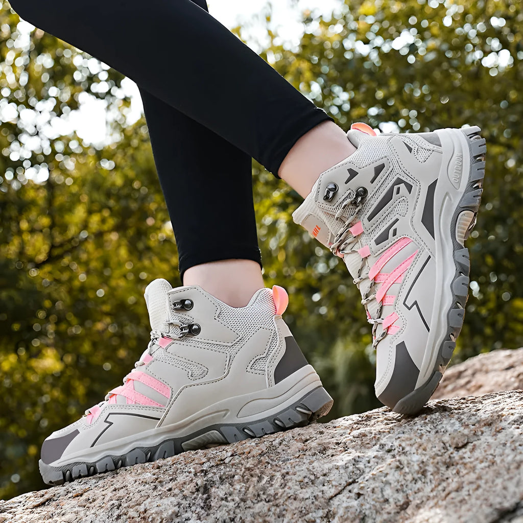 High-top outdoor hiking sneaker in flannel with rubber sole, shown on a rocky trail.
