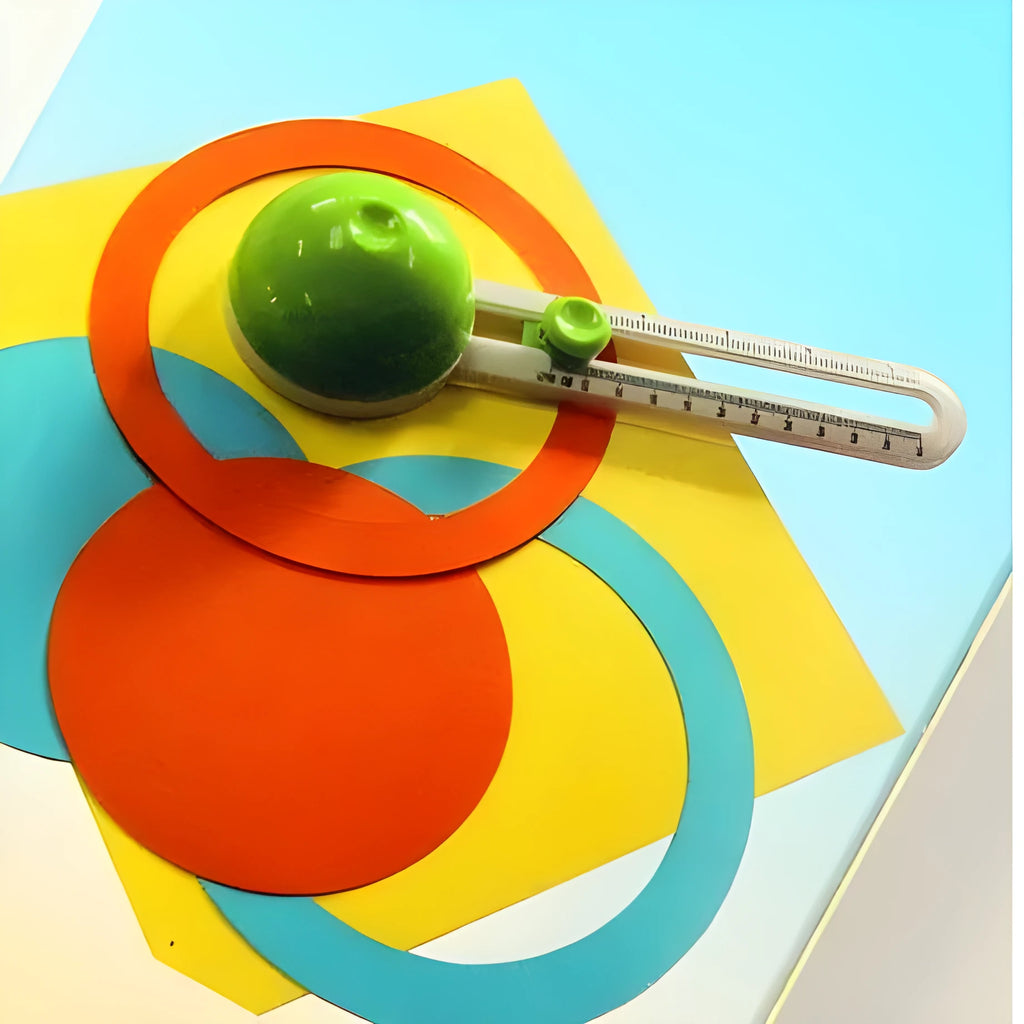Green or orange plastic round paper cutter for A3 paper on a colour box.