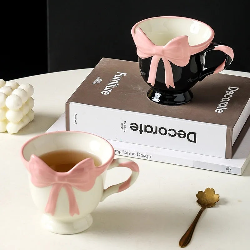 Ceramic mug with a cute girl heart bow design in black pink and white powder colours.