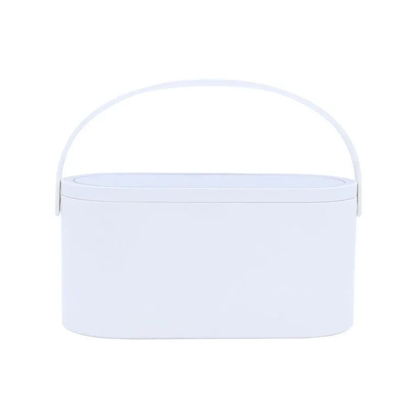 Portable LED light storage box beauty and makeup mirror with aluminium mirror lens in pink colour on a bedroom surface.