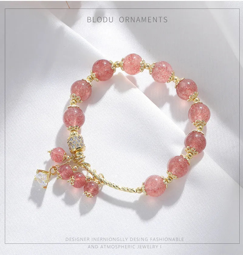 Pink strawberry quartz crystal heart-shaped women's bracelet with pearl accents.