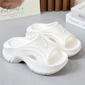 Women's thick-soled EVA slippers in white, black, and rose red colours showing round toe design