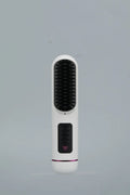 Portable negative ion hair comb in white, dark blue, or grey colour, showing compact size and teeth.