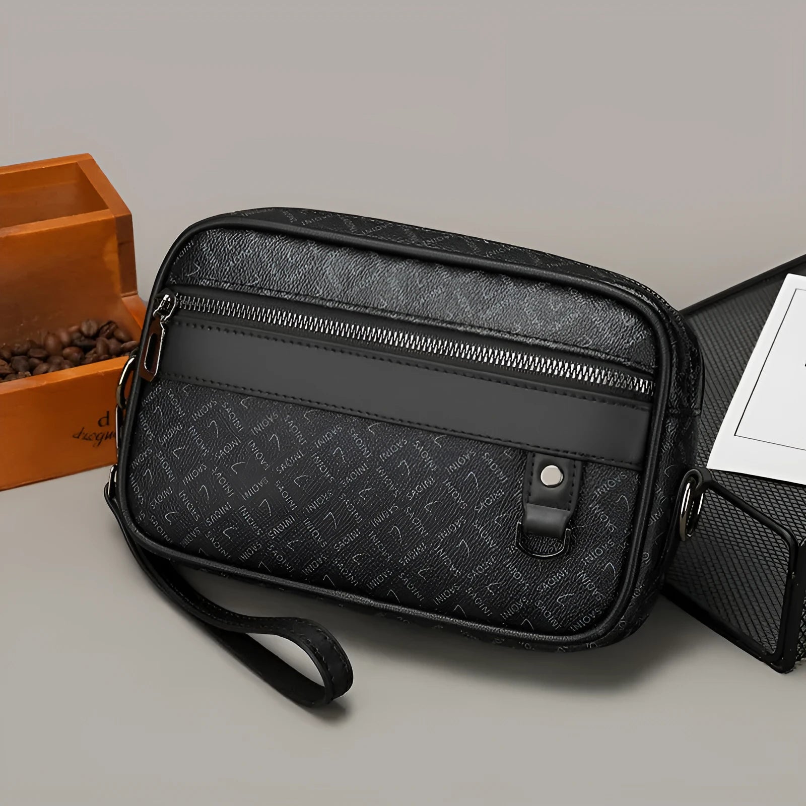 Men's black PU leather messenger bag with a geometric pattern, shown worn crossbody.