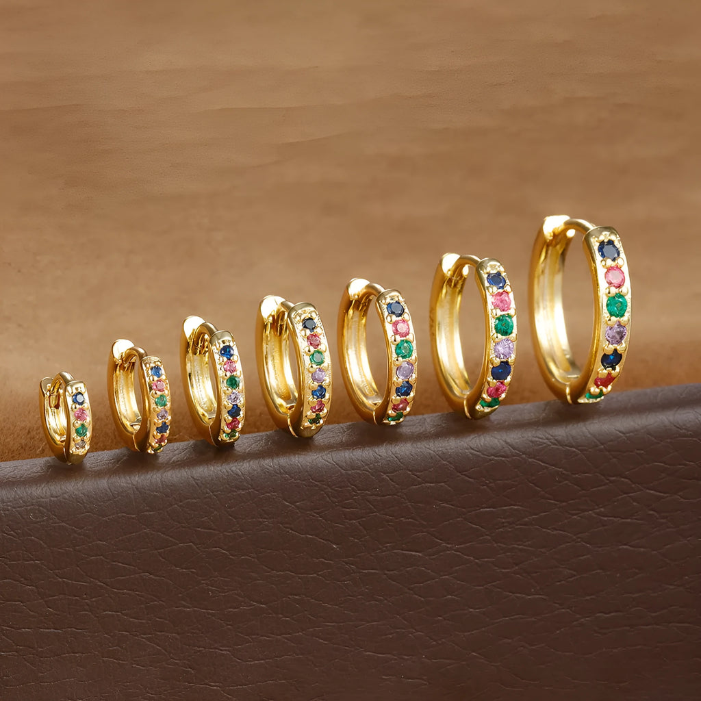 A pair of round geometric stud earrings with a perforated design in a gold electroplated finish.