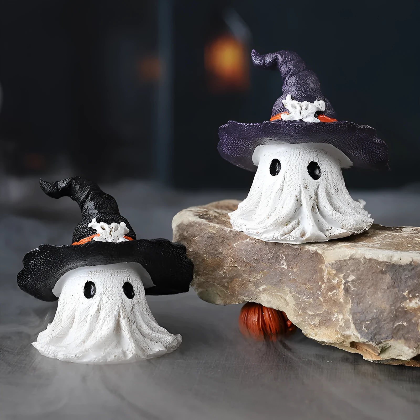 A detailed resin wizard hat ornament with a ghost theme in either kid-purple or black colour.