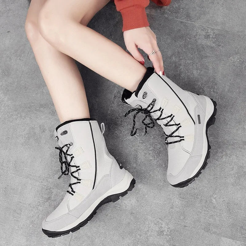Women's mid-calf thermal snow boots in black with a genuine leather upper and rubber sole.