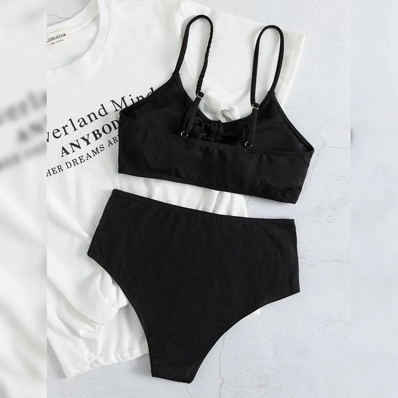 Black women's bikini swimsuit with high waist shorts and a sleeveless top on a mannequin.