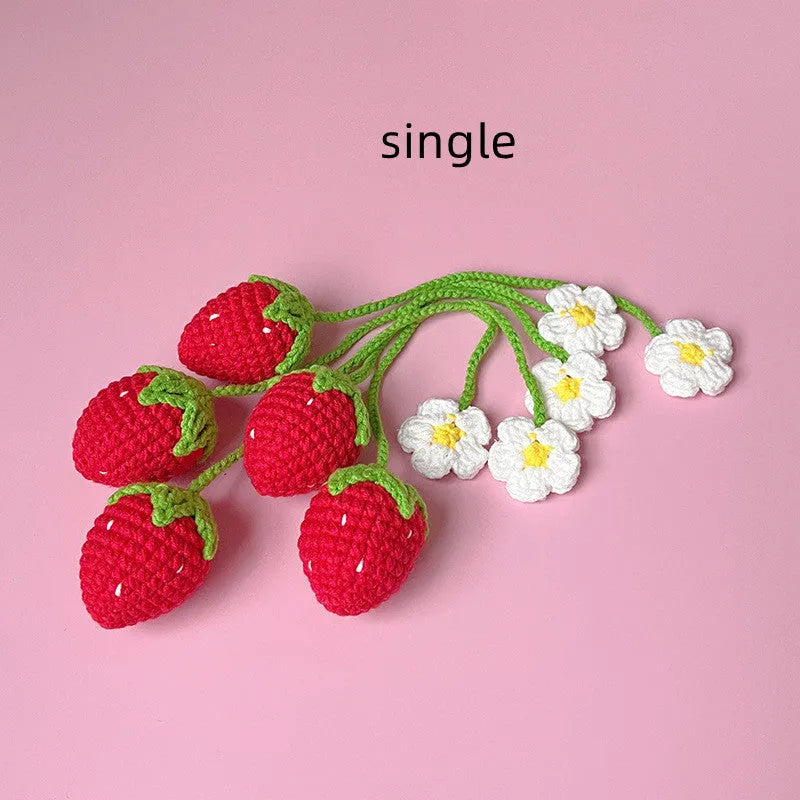 Red knitted wool strawberry pendant on 35cm cord against neutral background