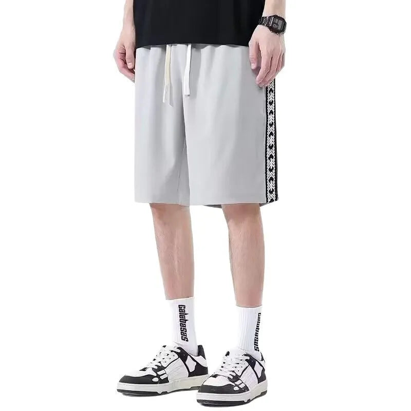 Men's black baggy track trousers with elastic waistband and loose sport fit