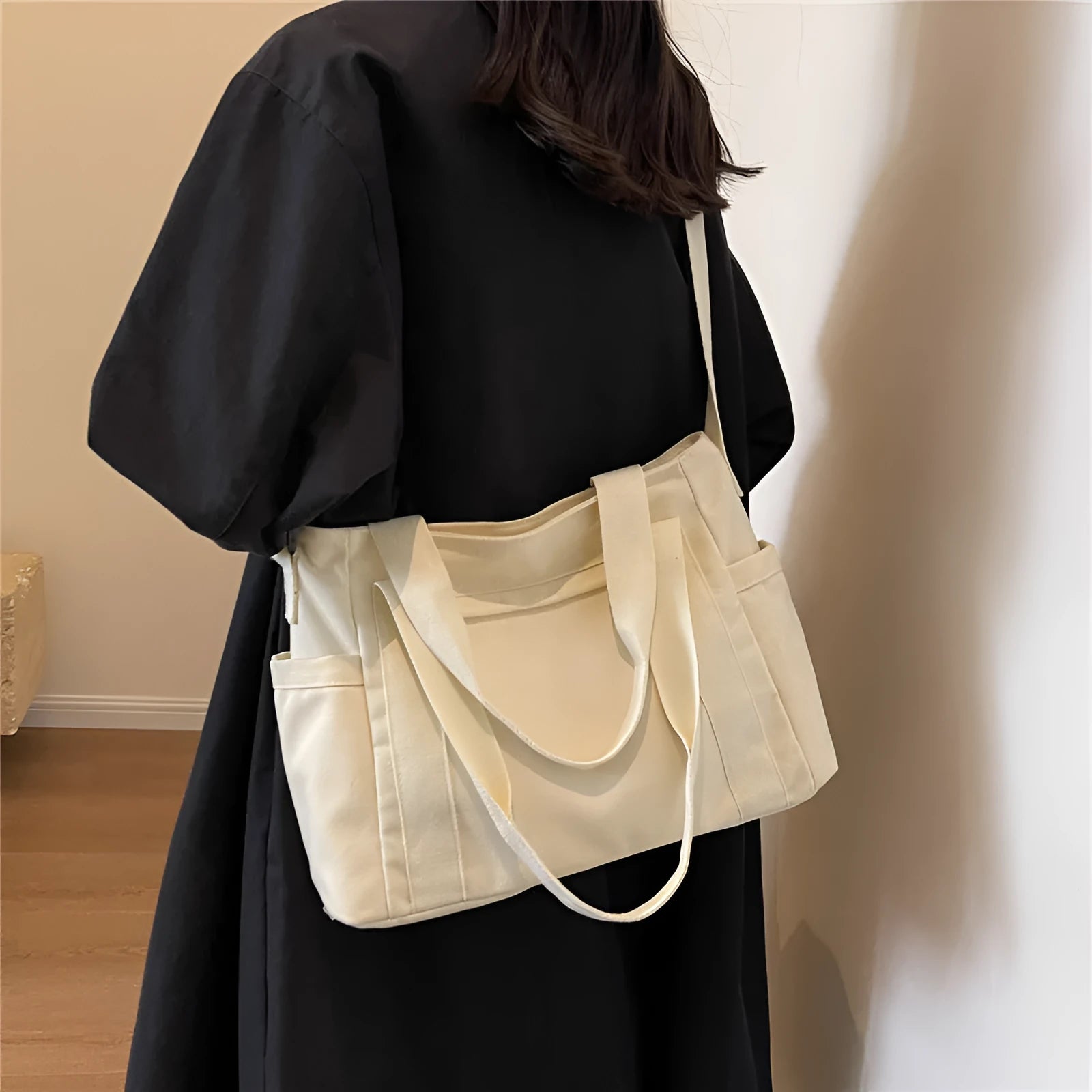 Women's large capacity canvas shoulder bag in solid colour with outer pocket and internal phone compartment