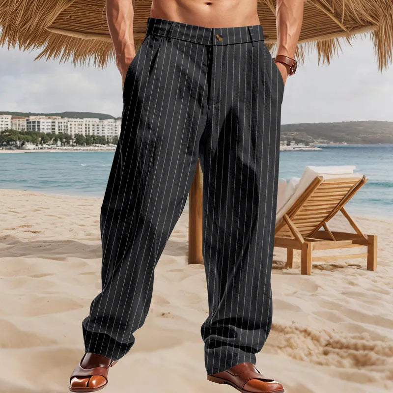 Man wearing straight-cut, high-waisted linen trousers with a wide leg and striped pattern in a light colour.