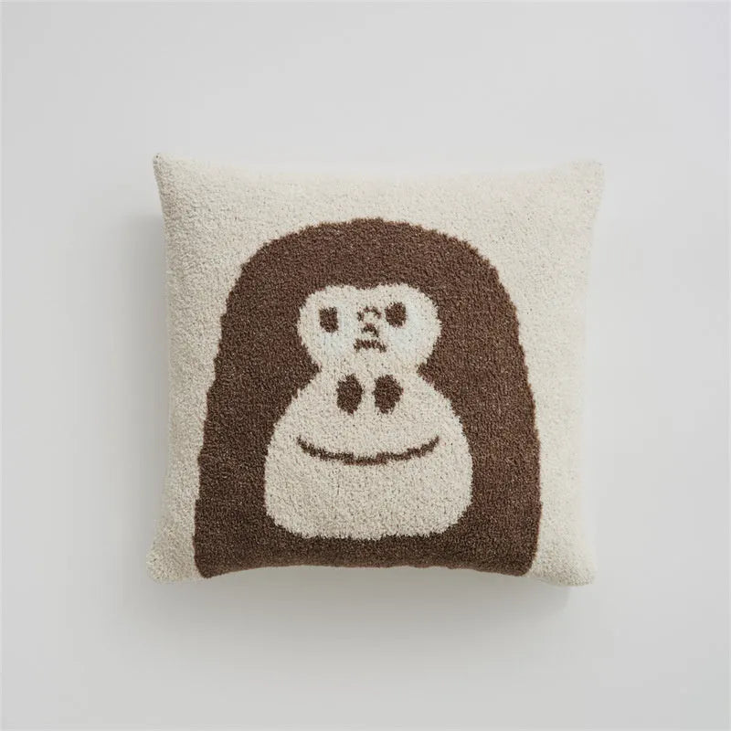 Cartoon anime knitted velvet pillowcase in black big face design on a bed