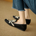 Women's beige retro flat pumps with embroidery detail, round toe, and a low-cut design on a soft bottom.