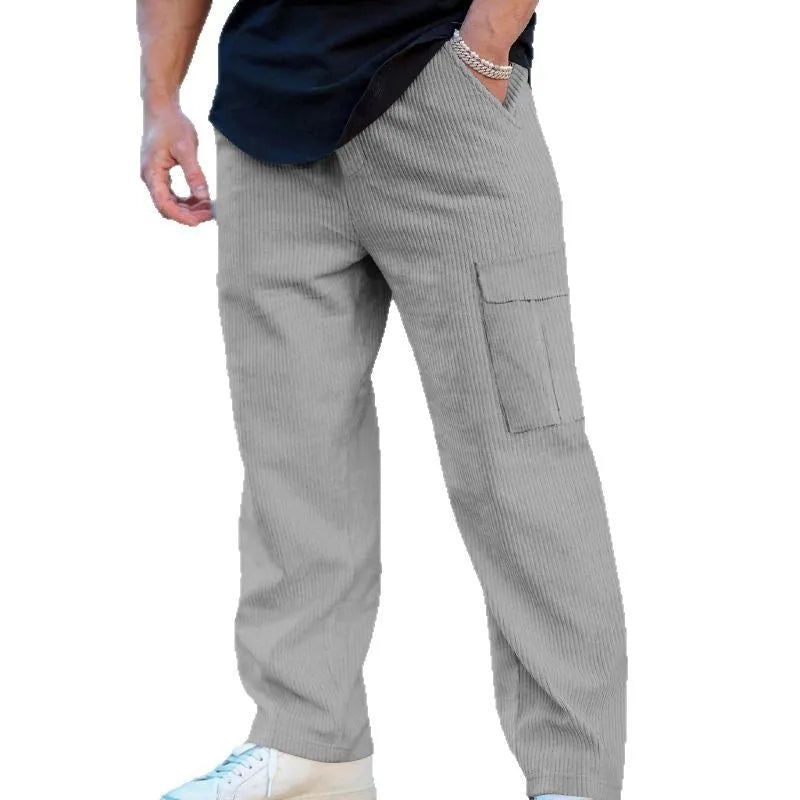 Men's navy blue corduroy cargo trousers with a drawstring waist and straight legs laid flat.
