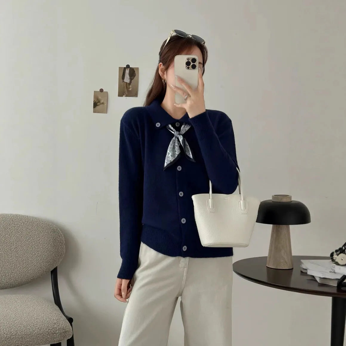 Beige lapel scarf cardigan sweater with long sleeves and splicing detail on a hanger.