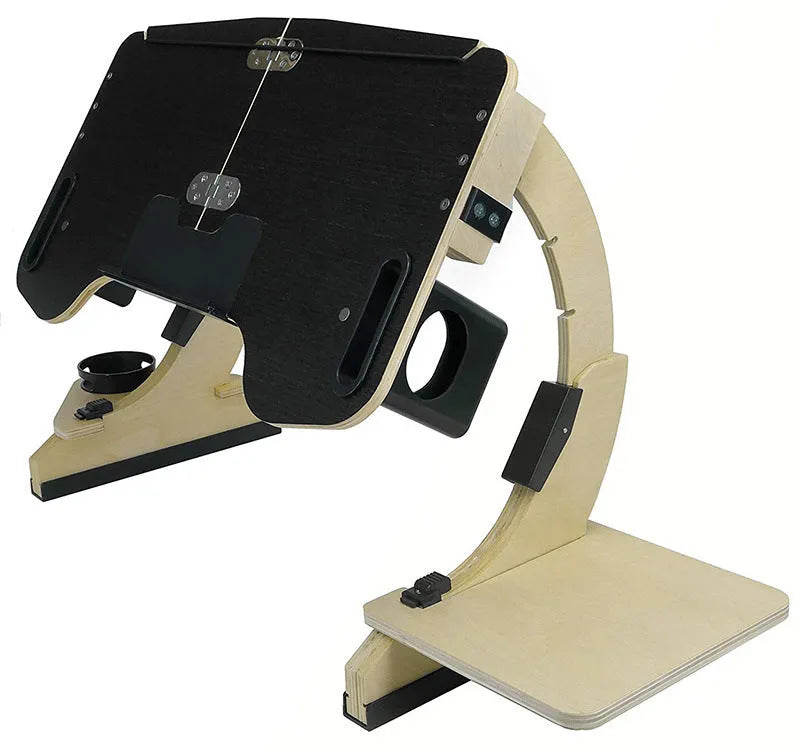 Wooden folding computer desk on a bed showing adjustable angle and laptop.