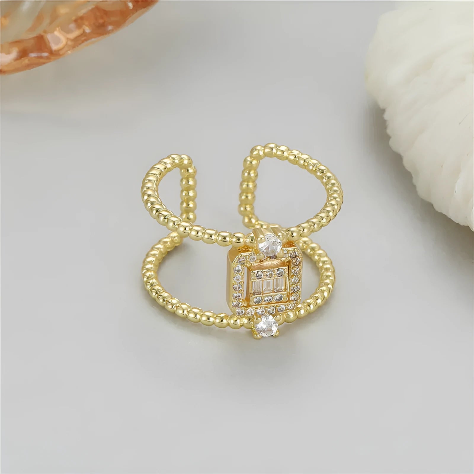 Adjustable opening copper ring with gold plate finish and asymmetrical U-shaped design