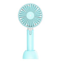Blue handheld mini electric fan with USB cable and three-speed control on desktop