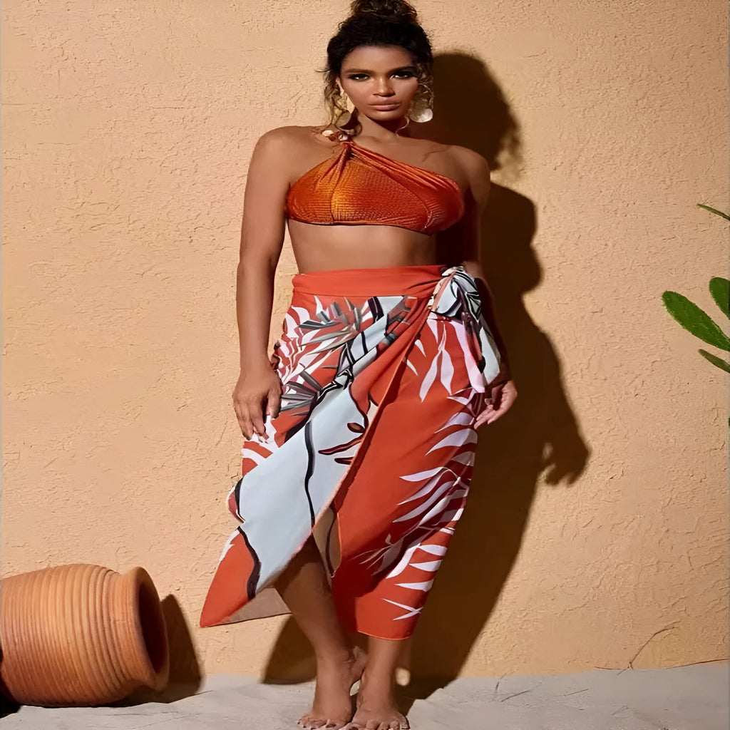 Women's brown push-up high-waist bikini with a matching chiffon skirt cover-up laid flat.