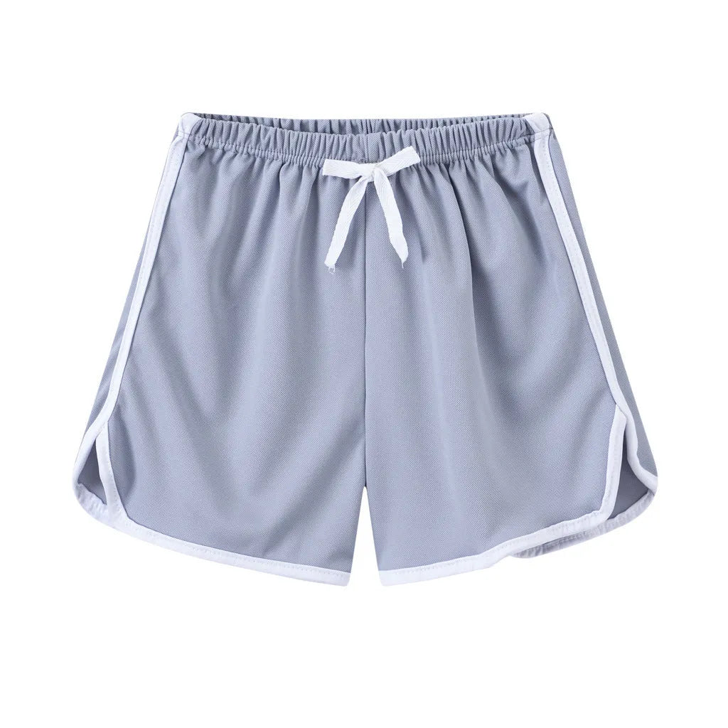 Children's colourful polyester shorts with elastic waistband, showing patterns like stripes, pineapples, and kittens.