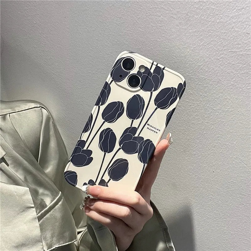 Black silicone iPhone case with a raised embossed tulip flower design on the back.