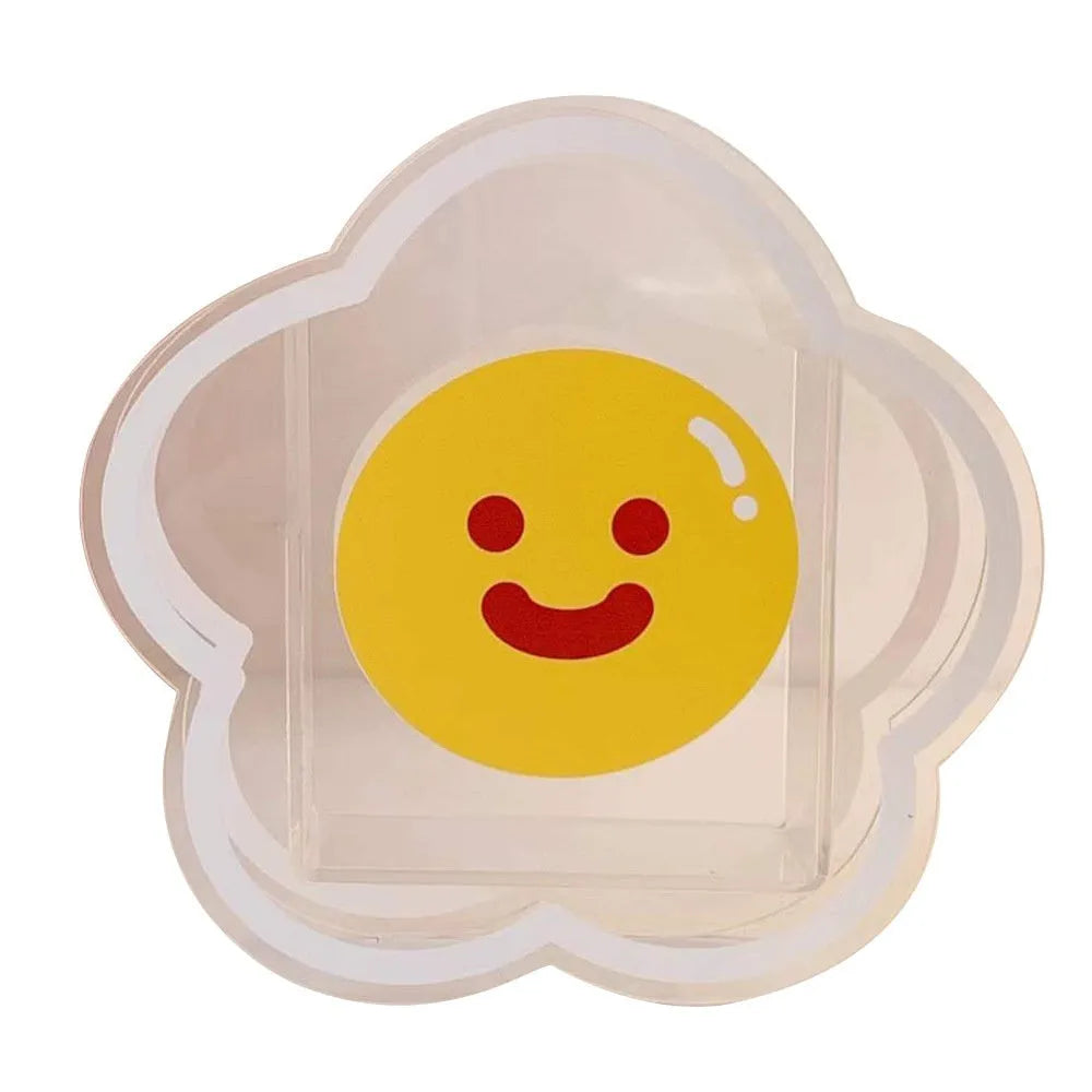 Clear square acrylic storage box with cute decorative design, shown holding pens and small items on a desk.