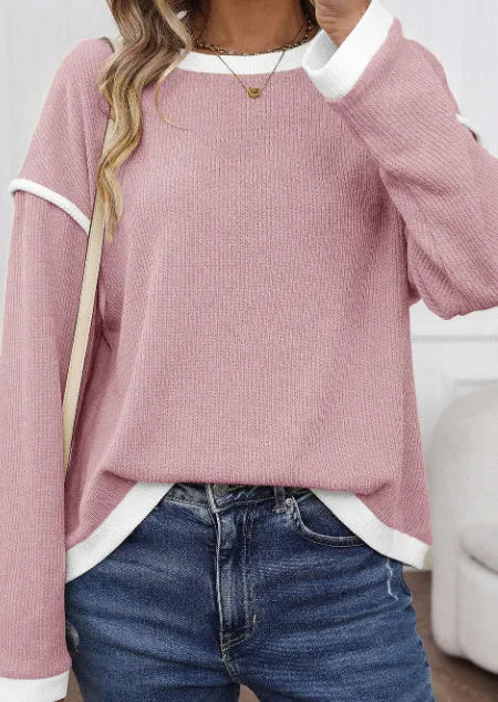 Drop shoulder loose knit top with four leaf clover contrast trim on the front, shown in beige.