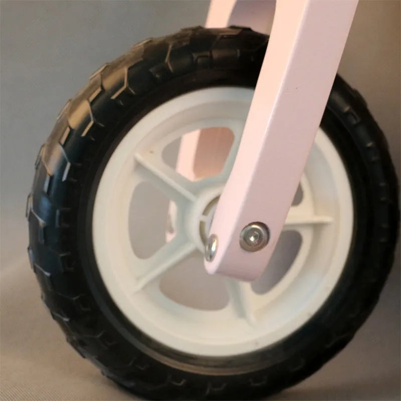 Pink wooden balance scooter for toddlers aged 1 to 6 years.
