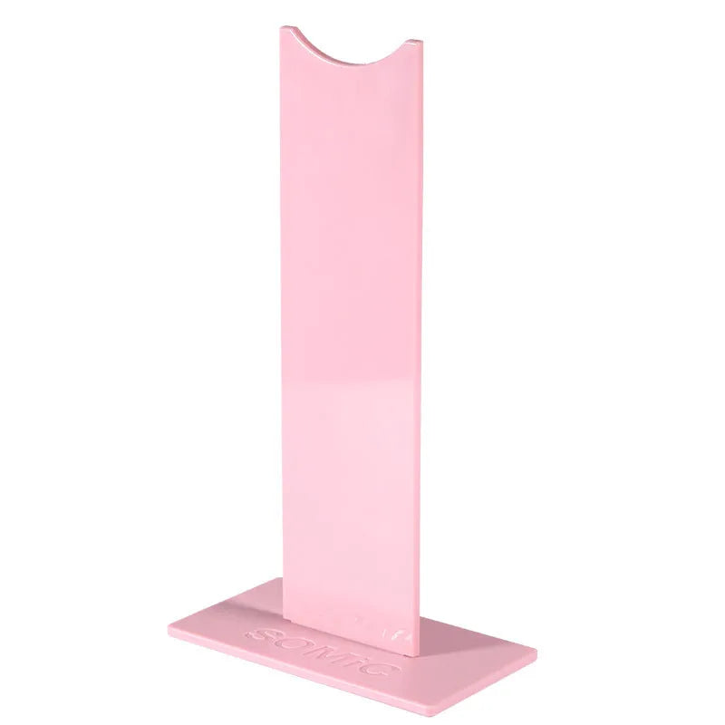 Pink detachable gaming headset stand with non-slip base on a desk, showing its disassembled parts.