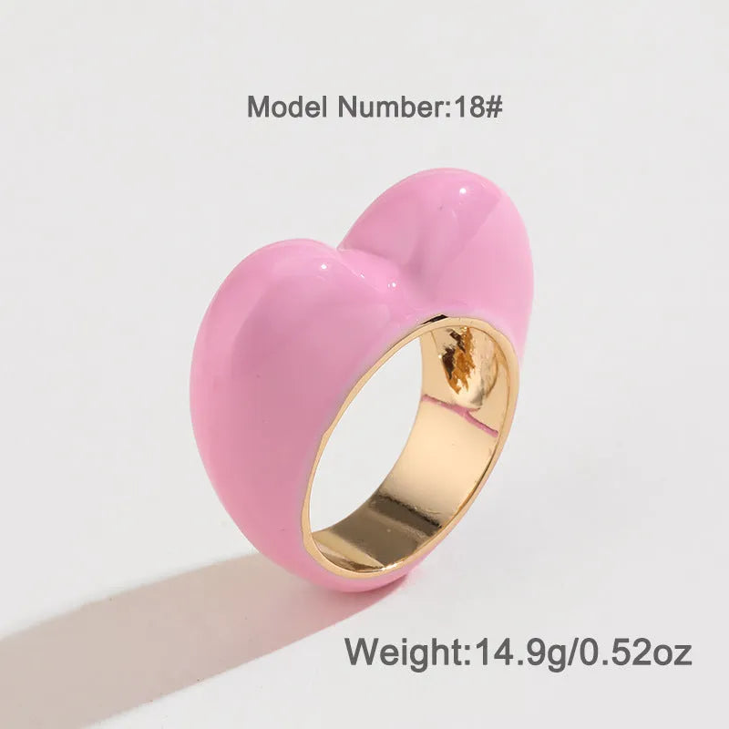 Three-dimensional enamel heart ring in multiple colours on a zinc alloy band.