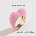 Three-dimensional enamel heart ring in multiple colours on a zinc alloy band.