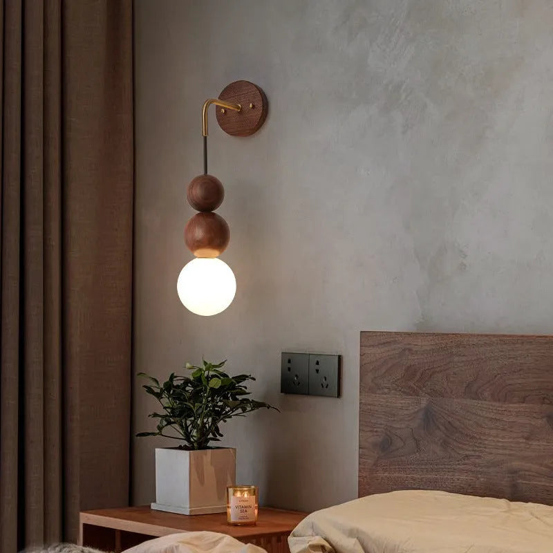 Wood and copper cylindrical wall lamp with suspension wire, showing Walnut and copper colour variants.