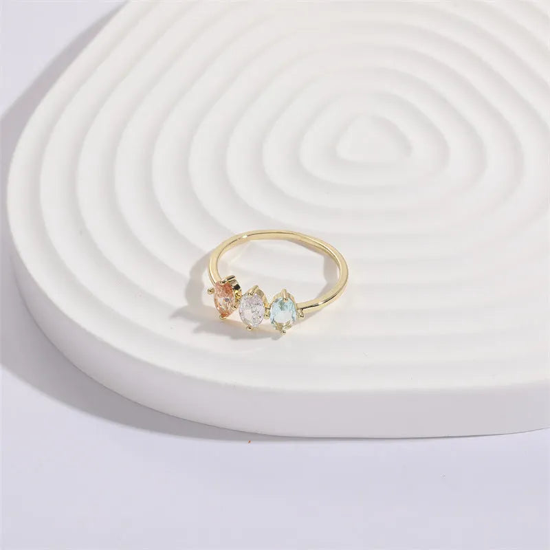 Geometric triangle copper ring with horse eye motif, tricolor zircon, and gold electroplate finish.