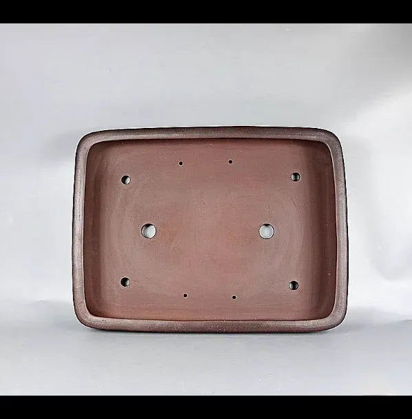 Handmade rectangular purple clay flower pot on a tabletop