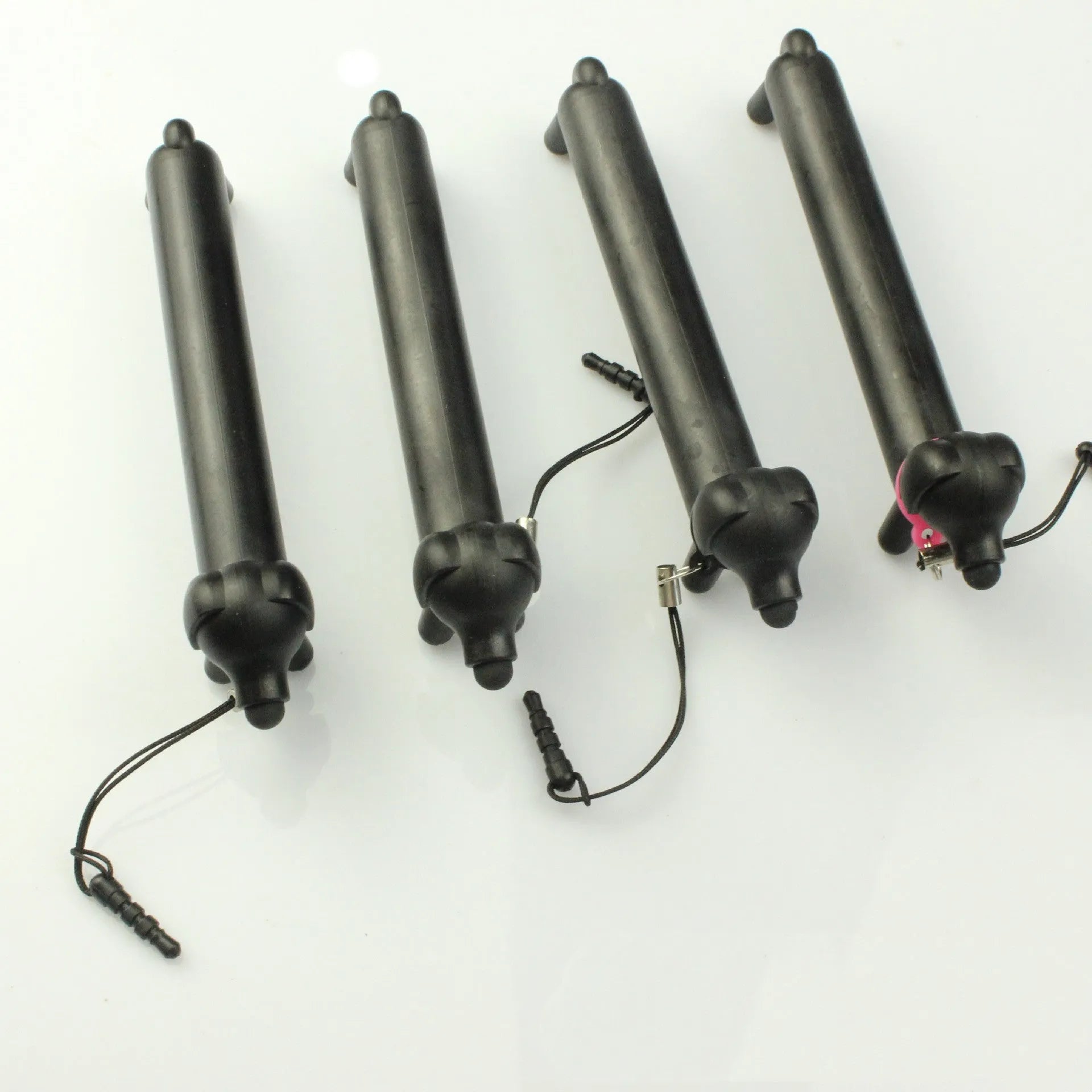 Black dog-shaped touch screen stylus with phone stand function on a white background