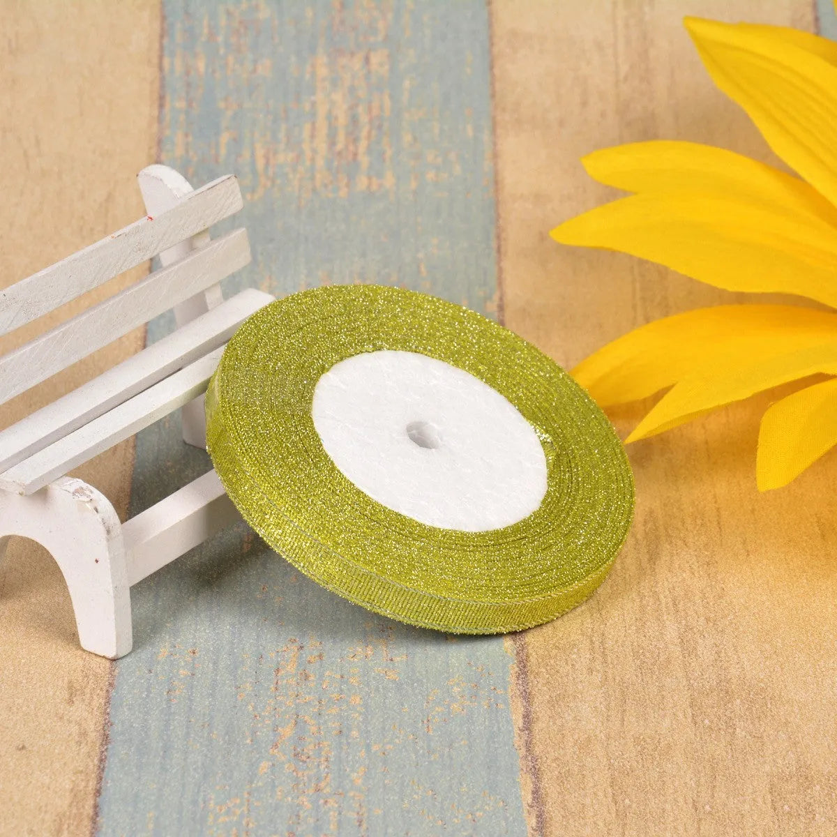 A roll of colourful green onion pattern polyester ribbon with metallic wire highlights, shown at 3-points width.