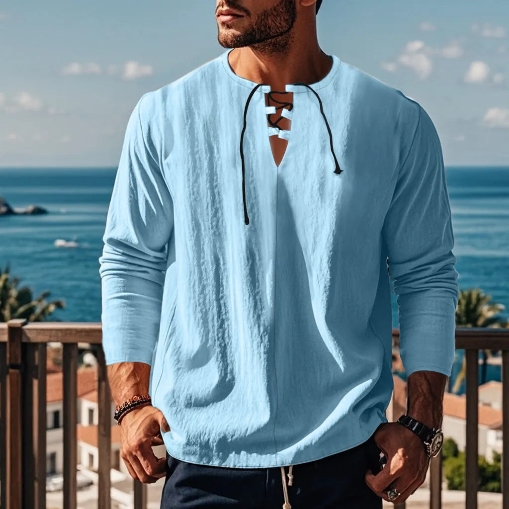 Cotton linen blend solid colour beach shirt in a loose pullover style on a hanger.