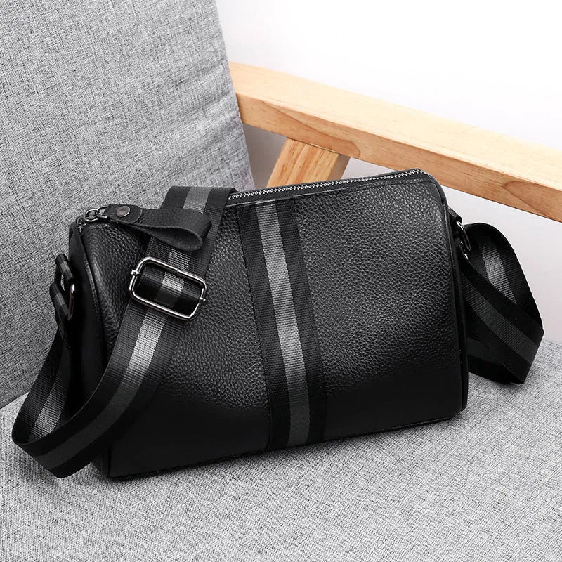 Black genuine leather women's crossbody bag showing front view and adjustable strap