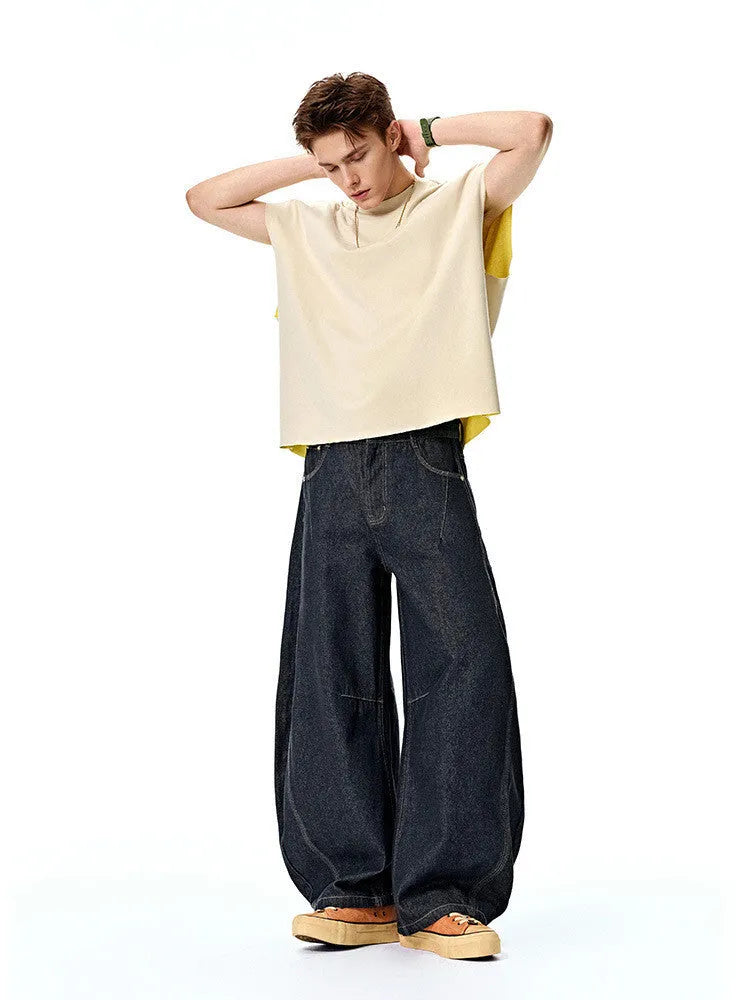 Men's original cow colour wide leg denim trousers laid flat, showing mid waist and straight leg cut.
