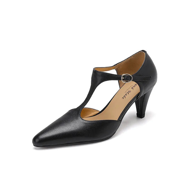 Brown retro women's sandals with T-strap, closed round toe, and a stout heel on a wooden background.