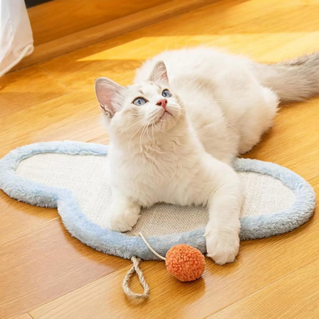 White wall-mounted cat scratching mat with natural sisal surface in a sleeping cat cartoon design.
