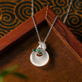 White ginkgo leaf pendant necklace with mixed gem inlay on silver electroplated O-ring chain